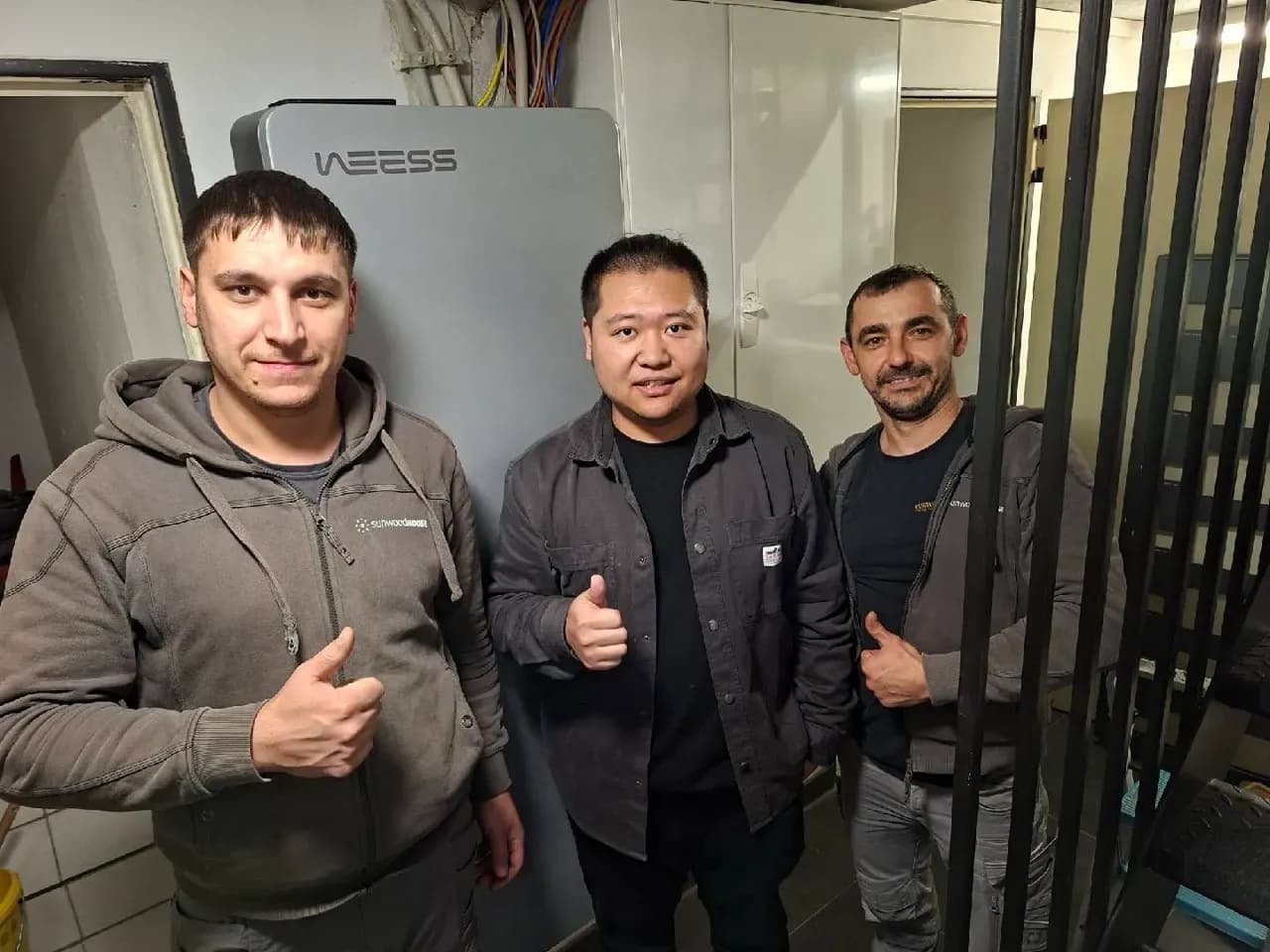 Installations-Team vor WEESS Energiespeicher nach erfolgreicher Inbetriebnahme